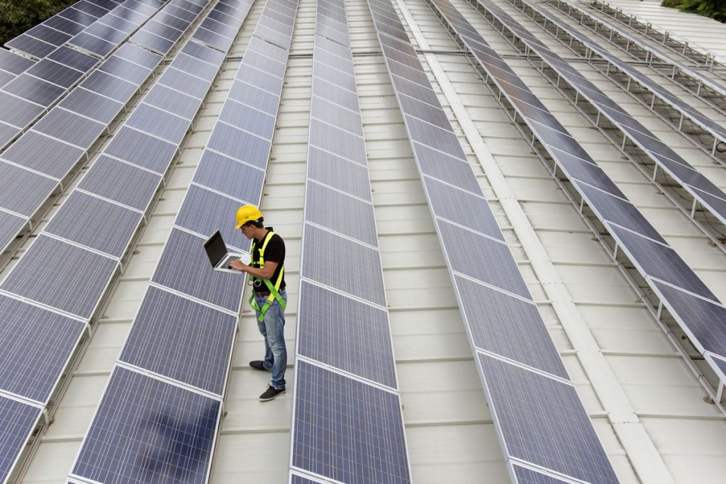 Image of an engineer gathering data in a photovoltaic farm on a roof top (ISO 200). All my images have been processed in 16 Bits and transfer down to 8 before uploading.