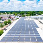 An array of solar panels on an urban rooftop